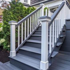 a gray and white staircase leading up to a house