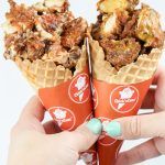 two waffle cones filled with fried food on top of each other