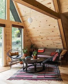 a living room filled with furniture and wooden walls