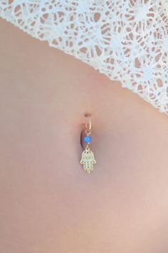 "A feminine and delicate Hamsa belly button ring made with a unique blue opal stone. This navel piercing is handmade of a 14k gold filled or Sterling Silver hoop and a Hamsa hand pendant. The Hamsa (or Hand of Fatima) is a middle-eastern symbol of good luck, to keep evil spirits away. Wear it or give it to a loved one to use as an amulet to give protection and good luck. Do not hesitate to contact me for special requests and customization! ♥♥ ▶ 14K Goldfilled or Silver wire 1.2 mm (16 gauge) wid Dangle Belly Ring As Gift, Adjustable Pierced Belly Rings As Gift, Dangle Belly Rings For Wedding, Dainty Hypoallergenic Body Jewelry Gift, Delicate Body Jewelry As Gift, Dainty Gold Belly Rings For Wedding, Bohemian Belly Rings As A Gift, Dainty Internally Threaded Belly Rings As Gift, Dainty Nickel-free Belly Rings As Gift