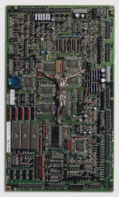 a computer motherboard with a crucifix on the top and wires all over it