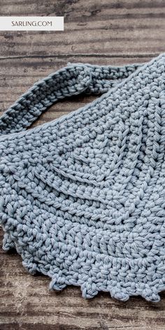 a crocheted bag sitting on top of a wooden table