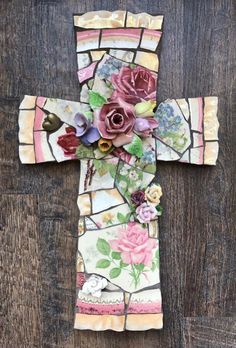 a cross made out of stained glass and flowers