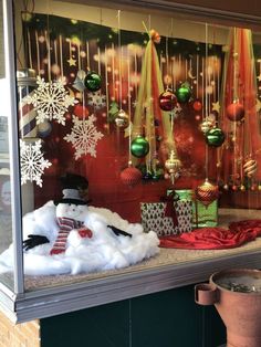 a window display with snowman and christmas decorations in it's windowsills