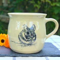 a ceramic mug with a drawing of a rabbit on it