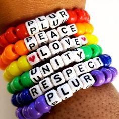 a woman's arm with four bracelets that say peace, love, and respect