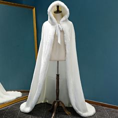 a mannequin with a white coat on it and a mirror in the background