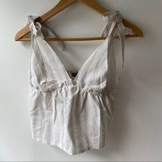 Adorable Top For Summer, Straps Tie At The Top. Never Worn Linen Tie Back Top For Brunch, White Summer Top With Tie Back, White Summer Tops With Tie Straps, Chic White Top With Tie Straps, White Tie-back Tops For Spring, White Tie-back Summer Top, White Tie Back Tops For Spring, White Tie-back Top For Brunch, White Vacation Tops With Tie Straps