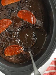 a pot filled with chocolate pudding and orange slices