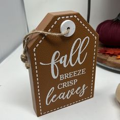 a brown tag that says fall breeze crisp leaves