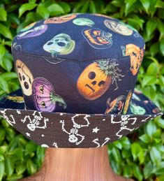 Wear your costume all year as a bucket hat. Fully reversible! Easy to wear, all cotton material with relaxed form holding interfacing, so you can tilt the brim in a variety of ways to your mood or style. These are sewn to your size Five standard sizes available. Please measure as these are a wearable item.  x-small - 21" small - 22" medium - 23" large - 24" x large 25" Wash delicate on cold or hand wash and hang to dry. Our mission is to inspire special needs individuals to make a business of what they love to do. This hat is handsewn by Henry, a special person. We support Henry's love of design, measuring, sewing, and tool working to create and sell one-of-a-kind sewing arts products.  By purchasing this product you are helping a special person have a job and be successful. Wear it with p Black Cotton Halloween Hat, Adjustable Skull Print Hats For Halloween, Adjustable Skull Print Halloween Hats, Fun Black Halloween Hat, Fun Brimmed Halloween Hats, Halloween Cotton Hat, Adjustable Cotton Halloween Hat, Adjustable Cotton Hat For Halloween, Black Halloween Hat With Skull Print