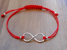 Red String Bracelet with an Infinity charm. The charm is made from a Sterling Silver .925 Adjustable size. Widest length - approx. 20 cm The item is stamped/marked .925! 100% guaranteed quality. Images are real and not processed with Photoshop. All of this can be seen in the photos. NOTE: Due to the difference device/monitors being used, pictures may not reflect the actual colour of the item. Copyright infringement is prohibited! Work only in sterling silver, not in chrome plated pewter. Do not Red Sterling Silver Jewelry For Friendship, Red Minimalist Sterling Silver Bracelets, Nickel-free Red Sterling Silver Bracelet, Red String Bracelet, Infinity Charm, Infinity Jewelry, Red String, Girl Jewelry, Silver 925 Necklace