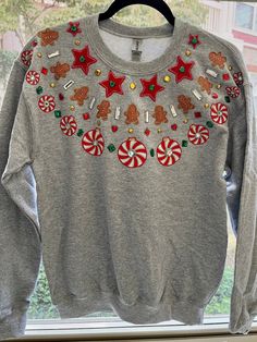 Reminiscent of the wildly popular puffy paint fashions in the 80's & 90's. Handmade fabric applique Christmas sweatshirt. Each motif is individually cut from 100% cotton fabric and collaged together to create a stunning arrangement. The finishing touches include multi-colored glitter puffy paint outlining each motif in addition to many rhinestones to add the perfect amount of sparkle.  Sizing: Adult unisex Gildan sweatshirt Puffy Paint Clothes, Puffy Paint Christmas Shirt, Puff Paint Christmas Sweatshirt Diy, Puffy Paint Sweatshirt, Festive Holiday Cotton Sweater, Christmas Festive Cotton Sweatshirt, Festive Christmas Cotton Sweatshirt, Festive Holiday Crew Neck Sweatshirt, Holiday Cotton Sweatshirt With Graphic Print