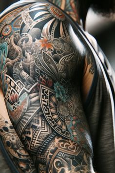 a man with tattoos on his arm and chest