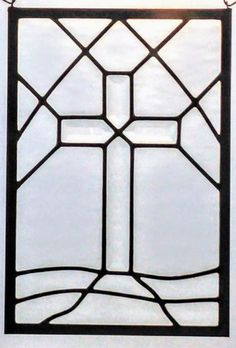 an old stained glass window hanging from a chain