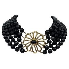 Make a bold statement with the Tiffany & Co. Paloma Picasso Onyx & Gold Necklace. Featuring sleek onyx beads accented with gold, this 14-inch necklace exudes contemporary elegance and sophistication. Designed by Paloma Picasso, it captures the essence of modern luxury and artistic expression, making it a versatile accessory for any occasion. Total Weight: 156.50g Clasp Size: 38mm x 38.8mm Length: 14" NS008 Paloma Picasso, Onyx Bead, Tiffany And Co, Paloma, Tiffany & Co., Modern Luxury, Onyx, Gold Necklace, Essence