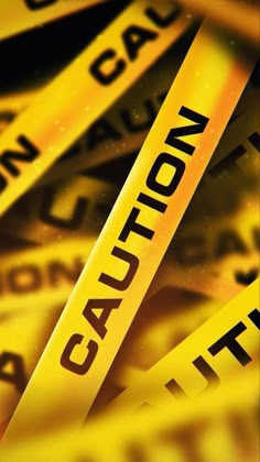 yellow caution tapes are stacked on top of each other with the word caution printed on them