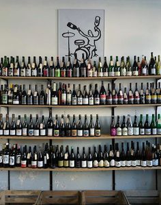 a wall full of bottles of wine on shelves