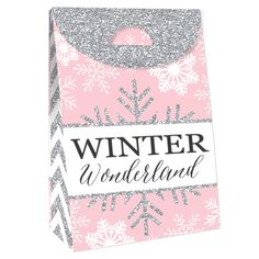 a pink and silver gift bag with glitter snowflakes on the front that says winter wonderland