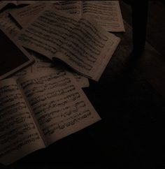 an open book with sheet music on the floor next to it's piano keyboard