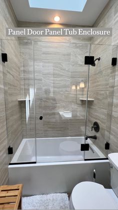 a white toilet sitting next to a bath tub under a skylight in a bathroom