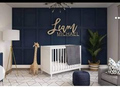 a baby's room with a giraffe in the corner and a name on the wall