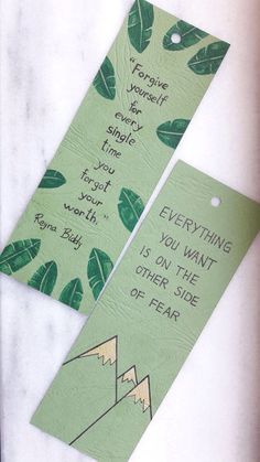 two bookmarks with green leaves on them, one has a quote and the other says everything you want is on the other side of fear