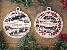 two christmas ornaments on top of a wooden table