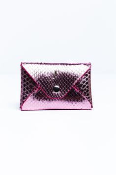 The Kenneth Mini Envelope Card Wallet. Hand-crafted with centuries-old European techniques, in a truly stunning mirror finish pink python. The perfect tiny wallet for the night out, this wallet fits in any pocket or bag and ensures you'll be able to carry your essential cards in high style wherever you go. A true 1 of 1 hottie. Features: Exterior - Mirrored Pink Python Interior - Pink French goat Hot foiled debossed logos Polished Nickel Button Closure Holds 5-10 credit cards or business cards P Affordable Pink Envelope Wallet, Luxury Pink Coin Purse For Gift, Luxury Pink Coin Purse As Gift, Pink Clutch With Card Slots For Gift, Pink Evening Clutch With Card Slots, Pink Clutch With Interior Card Slots For Gift, Pink Python, Mini Envelope, Pink French