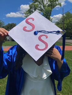 a person wearing a graduation cap with the letter s on it