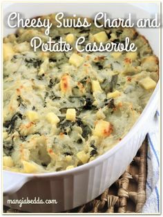 cheesy swiss chard and potato casserole in a white baking dish