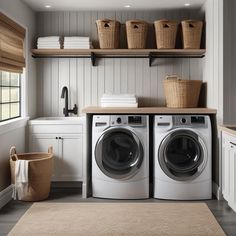 a washer and dryer sitting in a room next to some shelves with baskets on them