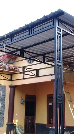 a large metal structure on the side of a building with stairs leading up to it