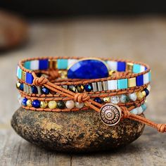 Let the Ocean inspire your Beauty with a Fascinating Ocean Blue Lapis Wrap Bracelet This Hand Made Beaded Wrap Bracelet is specially made for Bohemian stylish queens who are looking for a Charming Style inspired by the Magical Nature  This splendid Boho Beaded wrap Bracelet is carefully handmade with  Natural Lapis Lazuli  Stone charm added on A Genuine leather strands and a beautiful mix of natural stone beads and crystals. It features a Fascinating Mix of Blue Colors Giving you Magical Nature, Beautiful Beaded Bracelet, Treasure Jewelry, Boho Wrap Bracelet, Blue Charm, Handmade Leather Bracelets, Natural Stone Beads, Lapis Lazuli Stone, Beaded Wrap Bracelets