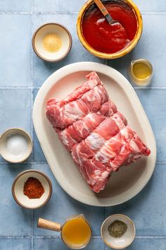 raw meat on a plate with spices and condiments