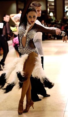 a man and woman dancing on the dance floor