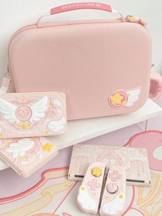 a pink suitcase and other items are on a white table with an artistically designed background