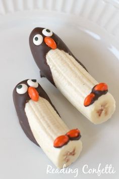 two frozen banana penguins sitting on top of a white plate