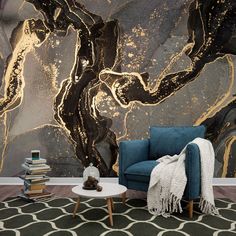 a blue chair sitting in front of a black and gold wallpapered room with books on the floor