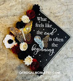 a graduation cap with flowers and butterflies on it that says, what feels like the end is often beginning