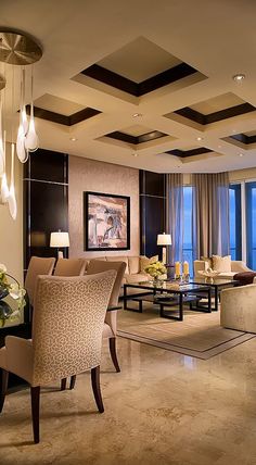 a living room filled with lots of furniture next to a large window covered in curtains