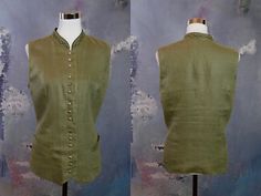 This women's green linen vest has a band collar with decorative stitching, and closes in the front with 15 quicksilver bulb buttons. The trachten waistcoat features figure-enhancing contouring seams on the front and back, and is lined in a green polyester fabric. Bust = 38 inches (96.52cm) Waist = 37 inches (93.98cm) Hips = 42 inches (106.68cm) Vest Length = 24 inches (60.96cm) Size: 8 US, 12 UK  Material: Linen Condition: Excellent (clean, soft, and supple, with no stains, tears, wear spots, or Fitted Vest With Stand Collar For Spring, Fitted Tops With Side Buttons For Spring, Fitted Green Vest With Button Closure, Green Buttoned Vest For Workwear, Green Vest With Buttons For Summer, Vintage Green Vest For Spring, Sleeveless Kimono, Linen Vest, Cream Jacket