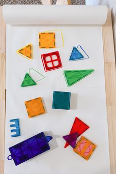 colorful plastic shapes are laid out on a sheet of paper