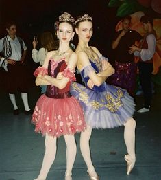 two young ballerinas are posing for the camera