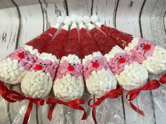 several marshmallows wrapped in red and white santa's faces are arranged on top of each other