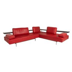 a red leather sectional sofa with metal legs