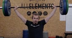 a man is lifting a barbell over his head