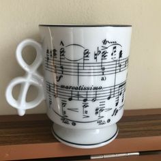 a white coffee cup with musical notes on it