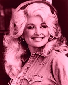 an old photo of a woman with long blonde hair wearing a denim shirt and headband