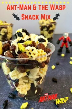 an ant - man and the wasp snack mix in a plastic cup with yellow sprinkles